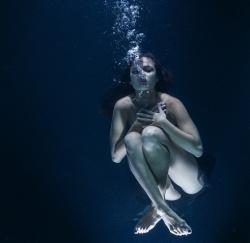 young woman in water as if in a dream
