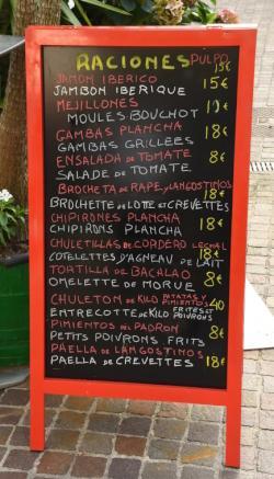 a menu board outside a restaurant